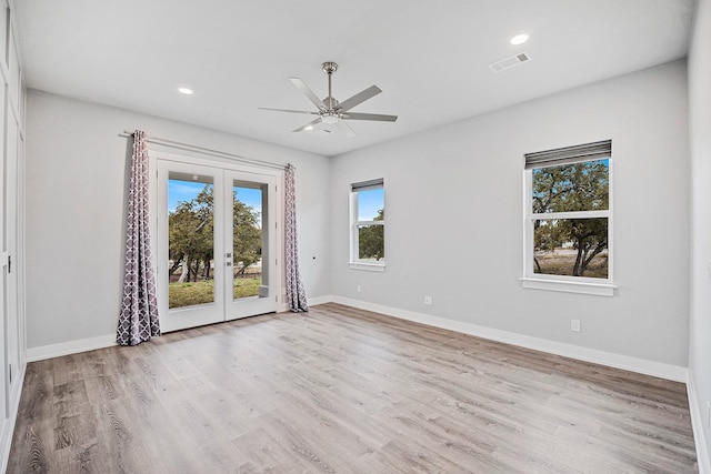 spare room with ceiling fan, light hardwood / wood-style flooring, and french doors