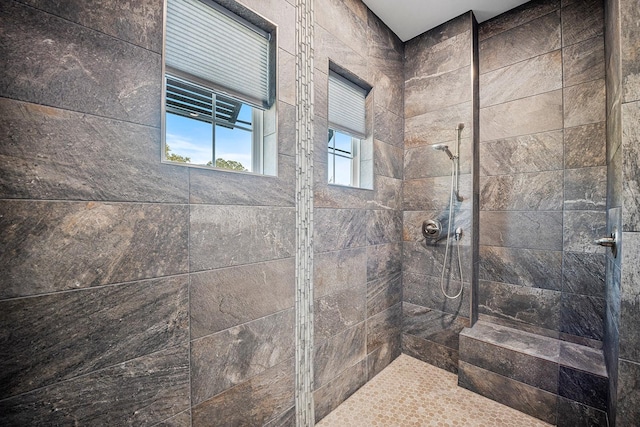 bathroom with tiled shower