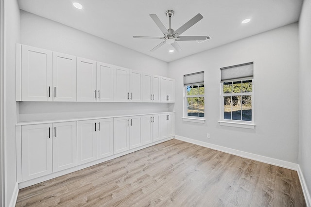 spare room featuring ceiling fan and light hardwood / wood-style flooring