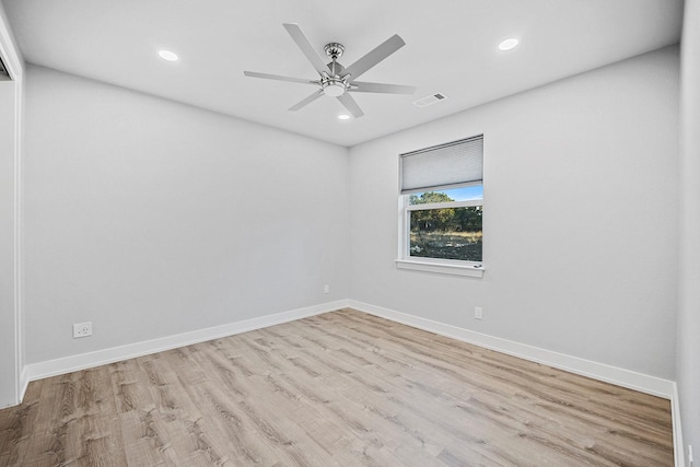 spare room with light wood-type flooring and ceiling fan