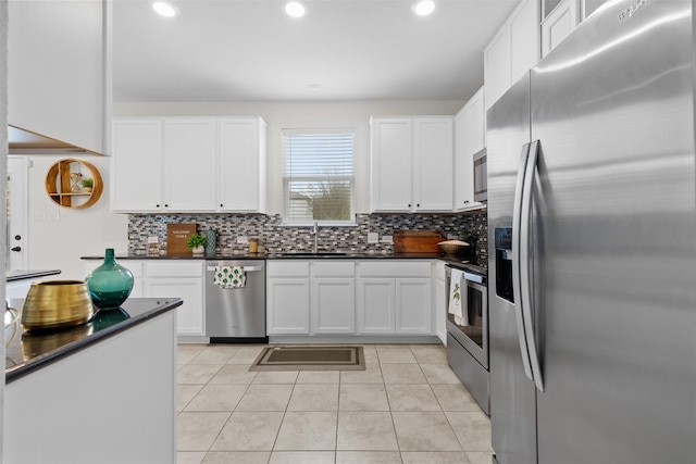 kitchen with sink, appliances with stainless steel finishes, and white cabinetry