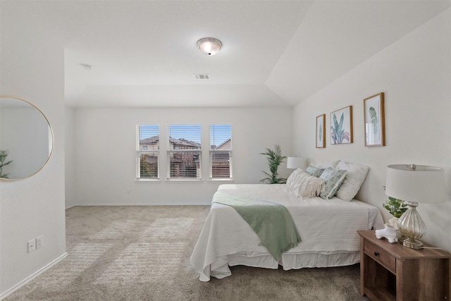 carpeted bedroom with lofted ceiling