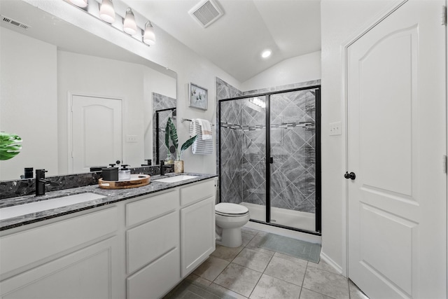 bathroom with toilet, tile patterned flooring, lofted ceiling, a shower with door, and vanity