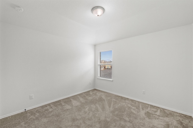 spare room with light colored carpet