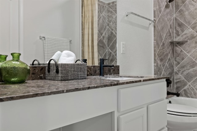 full bathroom featuring toilet, vanity, and tiled shower / bath combo