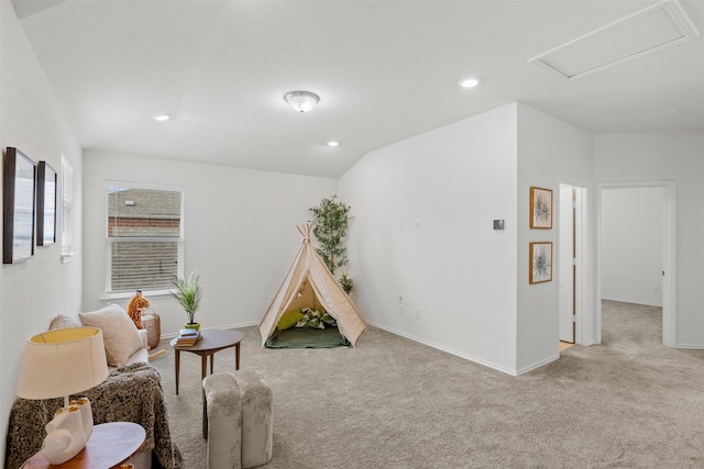 rec room featuring vaulted ceiling and light carpet