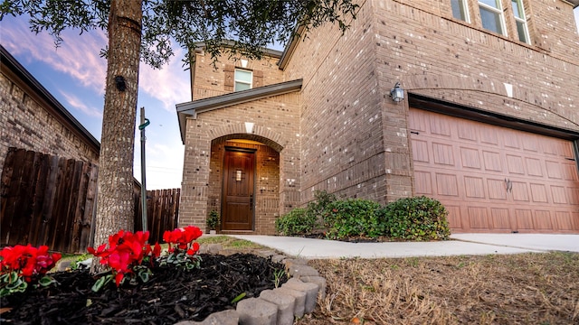 exterior entry at dusk with a garage