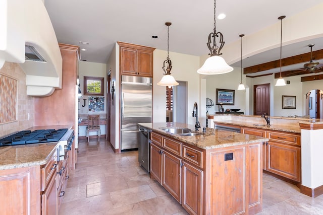 kitchen featuring decorative light fixtures, an island with sink, stainless steel appliances, beam ceiling, and sink