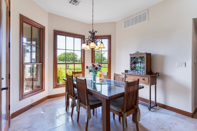 dining space with an inviting chandelier