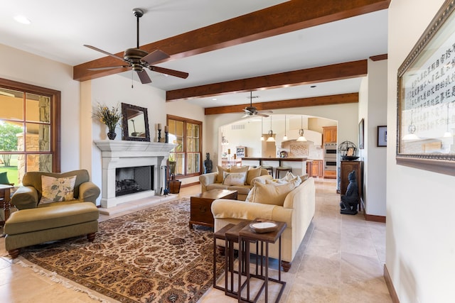 living room featuring beam ceiling and ceiling fan