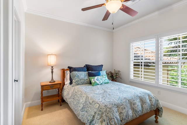 carpeted bedroom with ceiling fan and ornamental molding