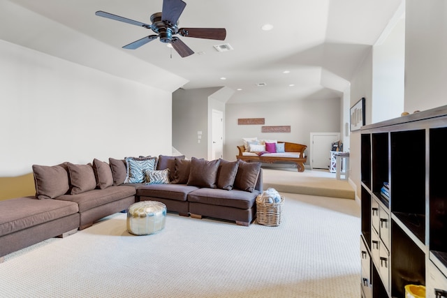 living room with ceiling fan, vaulted ceiling, and light colored carpet