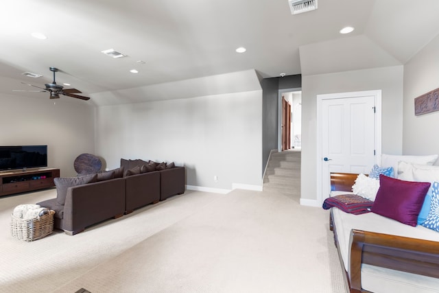 living room with light colored carpet, ceiling fan, and vaulted ceiling