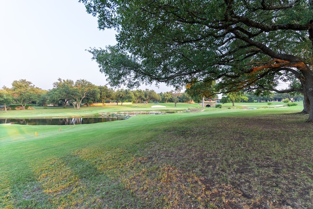 view of property's community with a yard and a water view