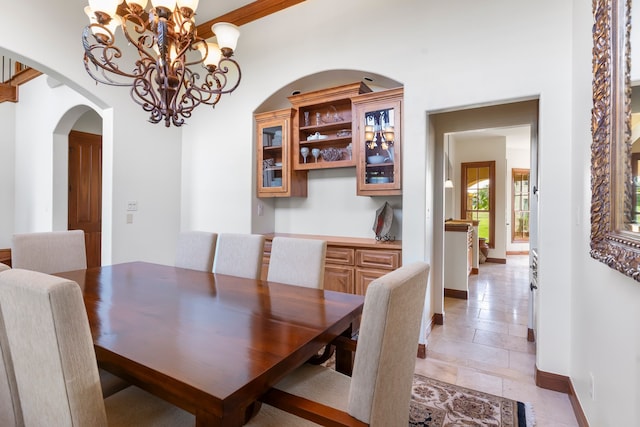 dining space with an inviting chandelier and light tile patterned flooring