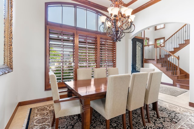 tiled dining space with a notable chandelier and crown molding