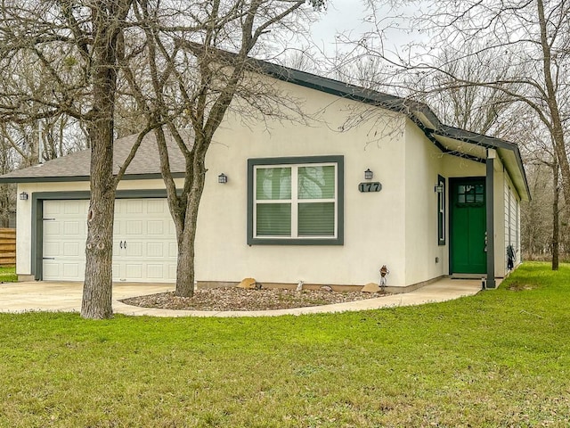 view of front of property with a front yard and a garage