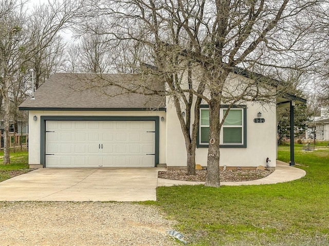 view of front of property featuring a front yard and a garage