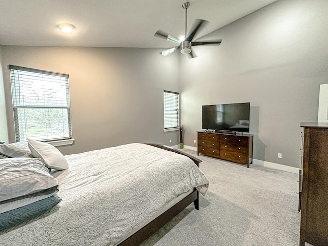 bedroom featuring ceiling fan, light colored carpet, and lofted ceiling