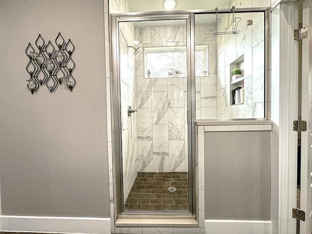 bathroom featuring a shower with shower door