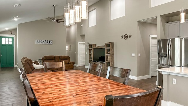 dining room with baseboards, high vaulted ceiling, ceiling fan, and dark wood-style flooring