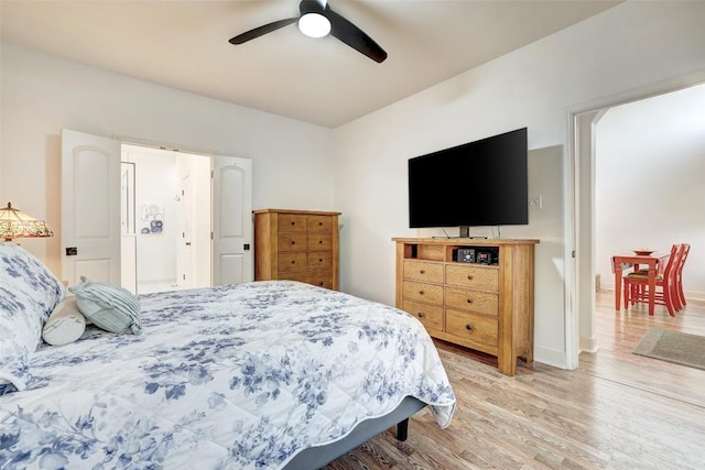 2210 Onion Creek Pkwy Unit 603, Austin, TX 78747 - bedroom with light wood-style floors, a ceiling fan, and baseboards