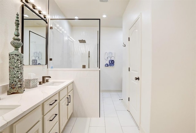 2210 Onion Creek Pkwy Unit 603, Austin, TX 78747 - bathroom with double vanity, recessed lighting, walk in shower, and tile patterned floors