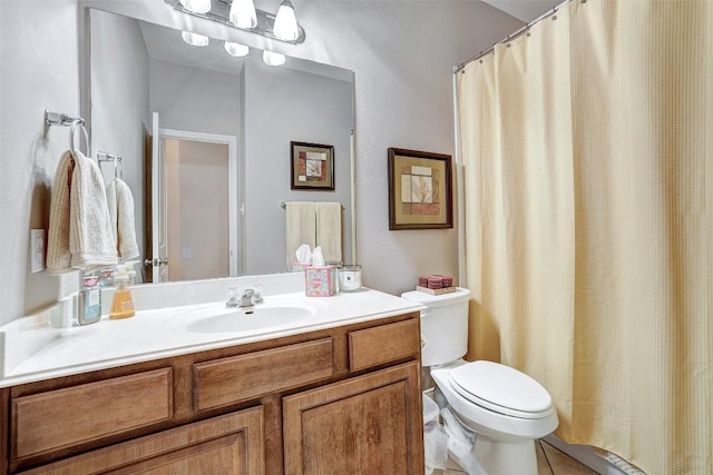 2210 Onion Creek Pkwy Unit 603, Austin, TX 78747 - bathroom featuring toilet, vanity, tile patterned floors, and curtained shower