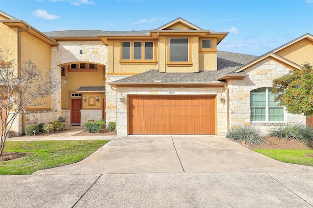 2210 Onion Creek Pkwy Unit 603, Austin, TX 78747 - view of front facade featuring stone siding, a garage, driveway, stucco siding, and a shingled roof