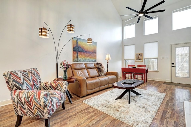 2210 Onion Creek Pkwy Unit 603, Austin, TX 78747 - living area featuring ceiling fan, high vaulted ceiling, plenty of natural light, wood finished floors, and baseboards