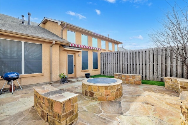 view of patio / terrace with grilling area, a fire pit, and fence