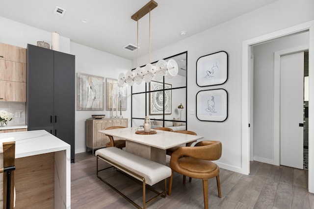 dining area with dark hardwood / wood-style flooring and a chandelier