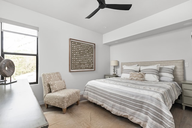 bedroom with hardwood / wood-style flooring and ceiling fan