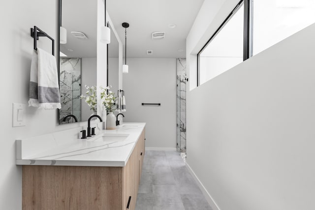 bathroom with vanity and a shower with shower door