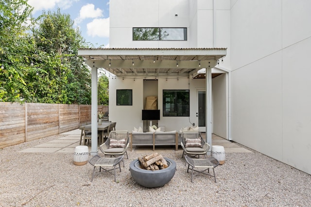 view of patio / terrace featuring an outdoor living space with a fire pit