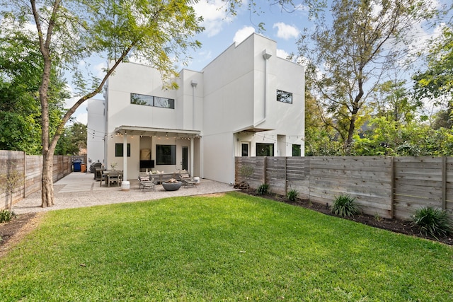 back of property featuring an outdoor hangout area, a patio area, and a lawn