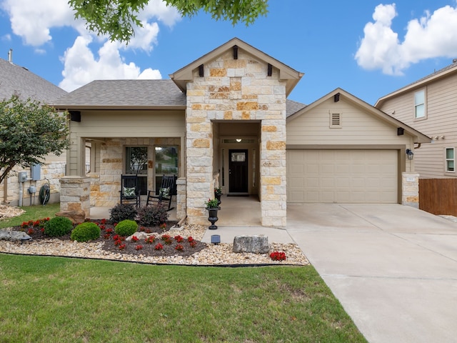 view of front of property with a garage and a front lawn