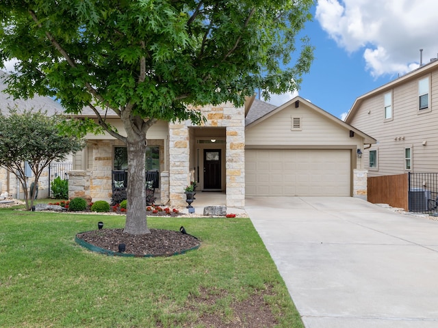 view of front of home with a front yard and a garage