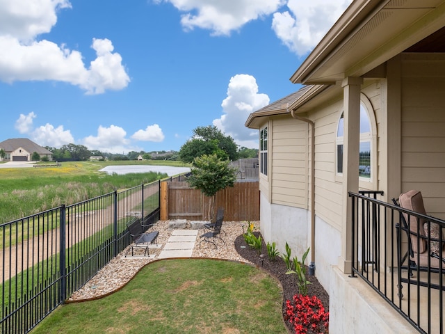 view of yard featuring a patio and a water view