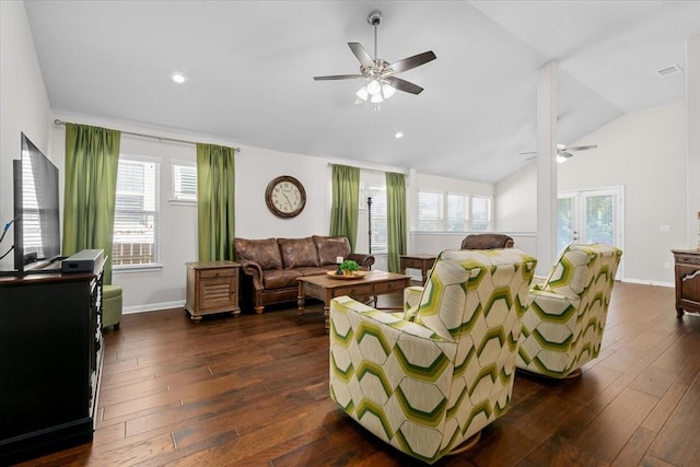 living room with lofted ceiling, a wealth of natural light, and dark hardwood / wood-style floors