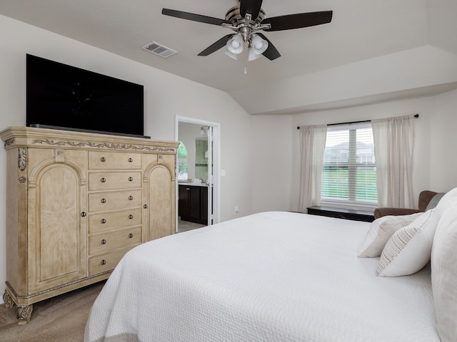 bedroom featuring lofted ceiling, ensuite bathroom, ceiling fan, and carpet flooring