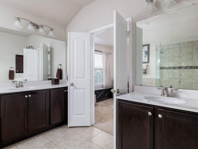 bathroom with vanity, tile patterned floors, a shower with shower door, and vaulted ceiling