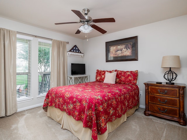 bedroom with ceiling fan and light carpet