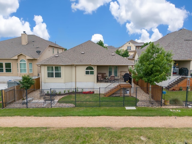 rear view of house with a yard