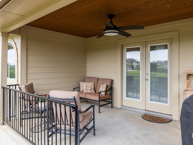 view of patio / terrace with ceiling fan, french doors, and a balcony