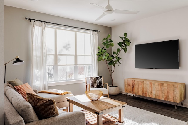 living room with ceiling fan and dark wood-type flooring