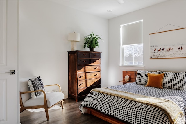 bedroom with dark wood-type flooring