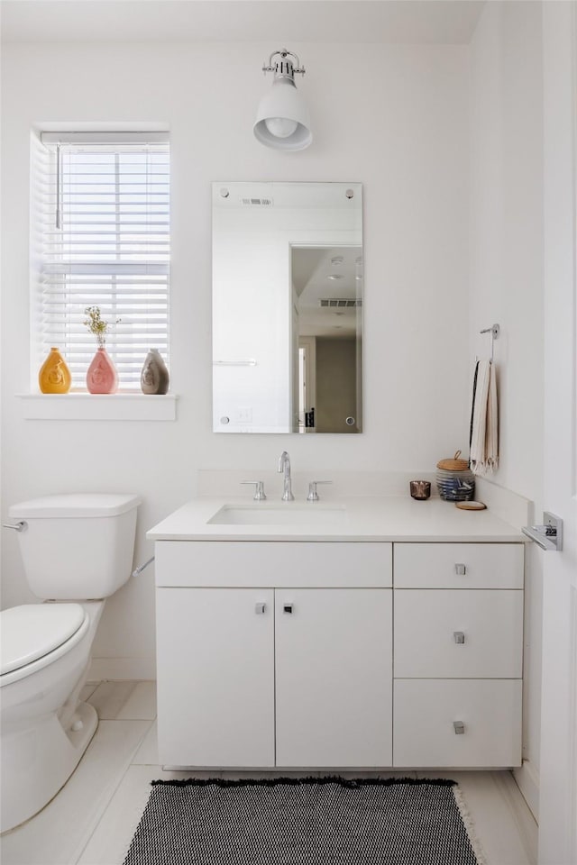 bathroom featuring vanity, toilet, and tile patterned floors