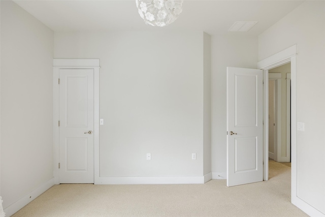 spare room featuring light colored carpet