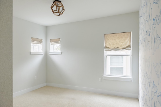 unfurnished room with light carpet